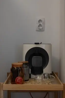 a microwave sitting on top of a wooden shelf at Belgrade Urban Central Flat in Belgrade