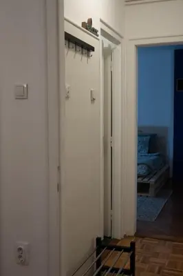 a hallway with a door to a room with a bed at Belgrade Urban Central Flat in Belgrade