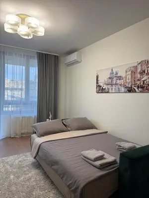 a bedroom with a bed and a painting on the wall at Belgrade Waterfront Apartment in Belgrade