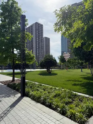 a light pole in a park with a grass field at Belgrade Waterfront Apartment in Belgrade