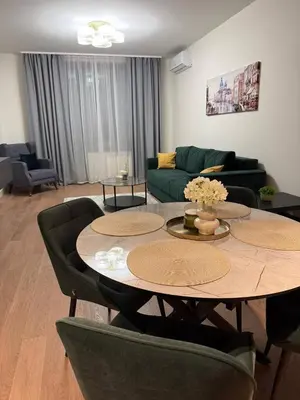 a living room with two tables and a couch at Belgrade Waterfront Apartment in Belgrade