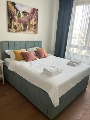 a bedroom with a large bed with towels on it at Belgrade Waterfront Apartment in Belgrade