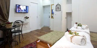 a hotel room with two beds and a table at Belle Apartments - Square 8 in Belgrade