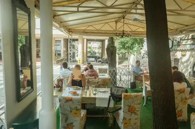 a group of people sitting at a table in a restaurant at Belle Apartments - Square 8 in Belgrade