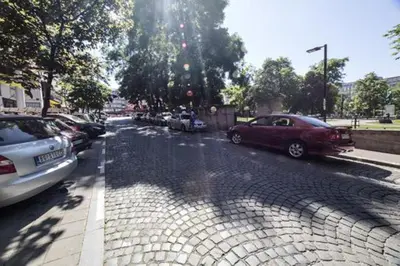 a street with cars parked on the side of the road at Belle Apartments - Square 8 in Belgrade