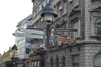 a street sign with street signs in front of a building at Belle Apartments - Square 8 in Belgrade