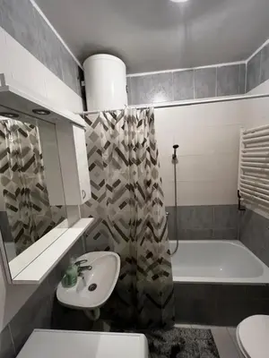 a bathroom with a sink and a toilet and a tub at Biser 4 in Belgrade
