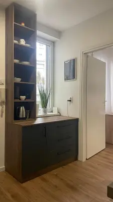 a living room with a dresser and a mirror at Studio 77 in Belgrade