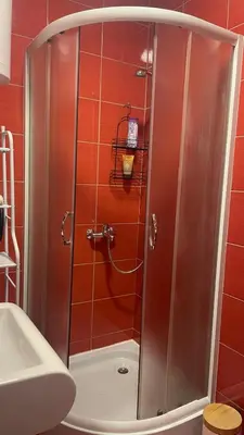a shower with a glass door in a bathroom at Studio 77 in Belgrade