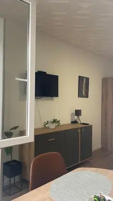a room with a desk with a tv on the wall at Studio 77 in Belgrade