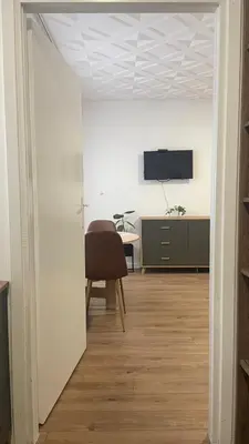 a room with a chair and a desk and a tv at Studio 77 in Belgrade