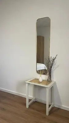 a white dressing table with a mirror on a wall at Studio 77 in Belgrade