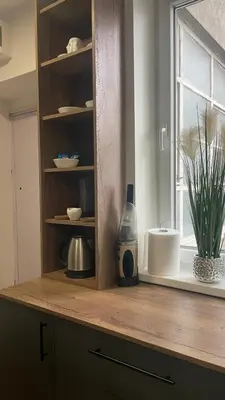 a kitchen counter with a window and a bottle on it at Studio 77 in Belgrade