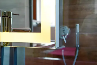 a mirror with a reflection of a toothbrush at Boutique Rooms in Belgrade