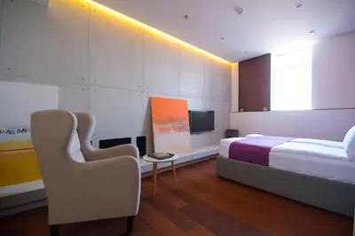 a bedroom with a bed and a table and chairs at Boutique Rooms in Belgrade