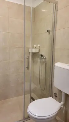 a bathroom with a glass shower with a toilet at Belgrade City Lux in Belgrade