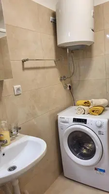 a bathroom with a washing machine and a sink at Belgrade City Lux in Belgrade