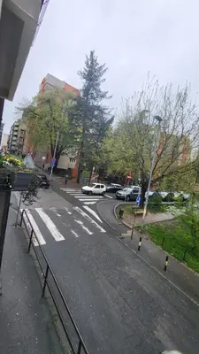 an empty street with cars parked on the road at Belgrade City Lux in Belgrade