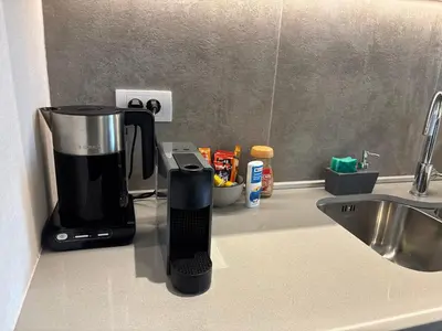 a coffee maker sitting on a counter next to a sink at BW Aqua Lux Premium Apartman in Belgrade