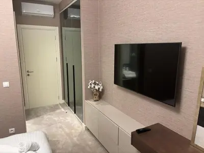 a living room with a large tv on a wall at BW Aqua Lux Premium Apartman in Belgrade