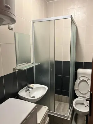a bathroom with a sink and a toilet and a mirror at Apartman S in Belgrade