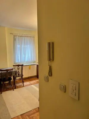 an open door to a living room with a table at Apartman S in Belgrade