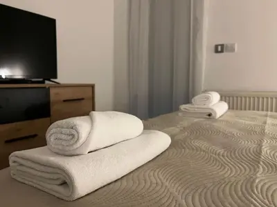 a hotel room with towels on a bed at Liberte Apartments Voždovac in Belgrade