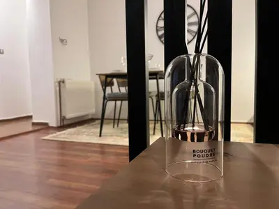 a glass vase sitting on top of a table at Liberte Apartments Voždovac in Belgrade