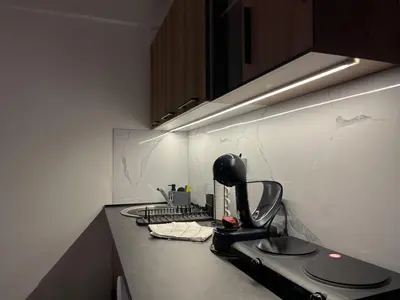 a kitchen counter with a coffee maker on it at Liberte Apartments Voždovac in Belgrade