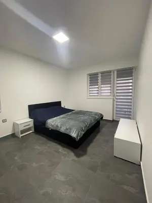 a bedroom with a bed and a white table at Vila Mila Ćirić in Pančevo