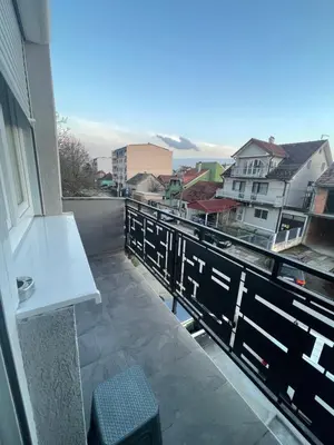 a balcony with a bench and a view of a city at Vila Mila Ćirić in Pančevo