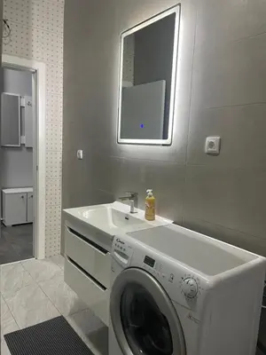 a washing machine in a bathroom with a sink at Vila Mila Ćirić in Pančevo