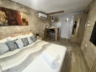a bedroom with a large white bed and a desk at Entire Place In Zemun in Belgrade