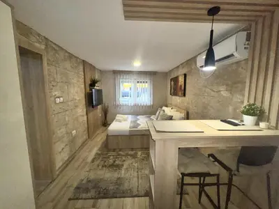 a small room with a bed and a desk in it at Entire Place In Zemun in Belgrade