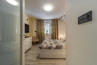a bedroom with a bed with a teddy bear on it at Kapetan apartman in Belgrade
