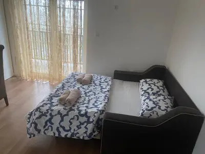 a bedroom with a bed with two towels on it at Apartmani Amon in Meljak