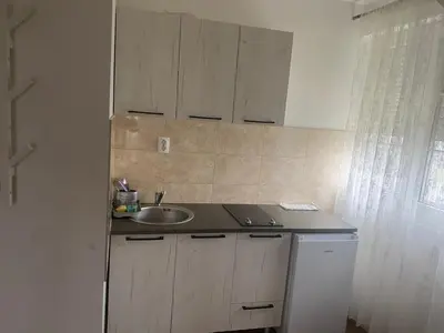 a kitchen with a sink and a counter top at Apartmani Amon in Meljak