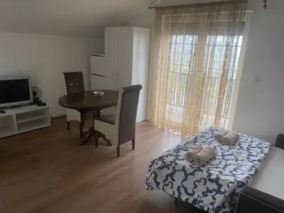 a room with a table and a bed and a dining room at Apartmani Amon in Meljak