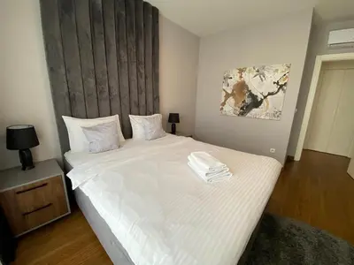 a bedroom with a large bed with white sheets at Bw Sky View3,Belgrade Waterfront in Belgrade
