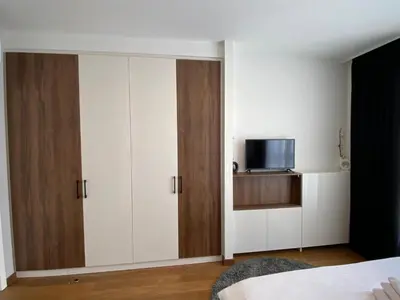 a bedroom with white cabinets and a television at Bw Sky View3,Belgrade Waterfront in Belgrade