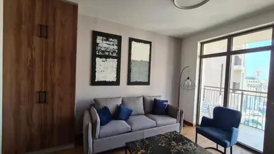 a living room with a couch and a blue chair at Bw Sky View3,Belgrade Waterfront in Belgrade