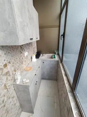 a small bathroom with a sink and a shower at White Apartment Slavija in Belgrade