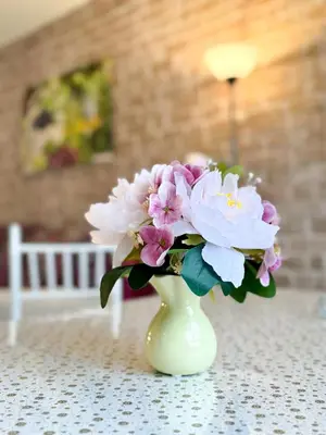 a vase filled with pink and white flowers on a table at Hopovske Terase in Irig