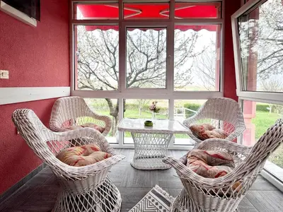 a room with chairs and a table and a window at Hopovske Terase in Irig