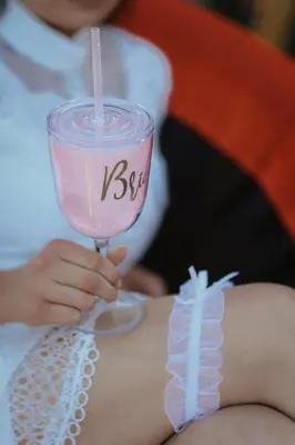 a woman is holding a glass of pink drink at Hopovske Terase in Irig