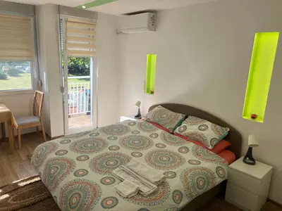 a bedroom with a bed with a towel on it at Fontana in Belgrade
