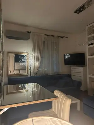 a living room with a glass table and a couch at Lux Beba Pancevo in Pančevo