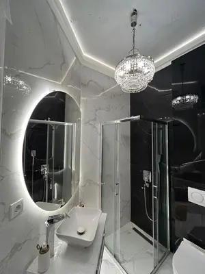a bathroom with a shower and a sink and a mirror at Lux Beba Pancevo in Pančevo