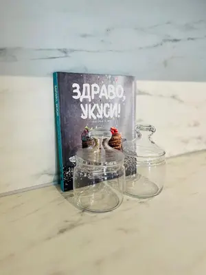 a book and two glass bowls on a counter with a book at BW Eterna Apartment in Sajmište