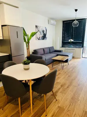 a living room with a table and a couch at BW Eterna Apartment in Sajmište